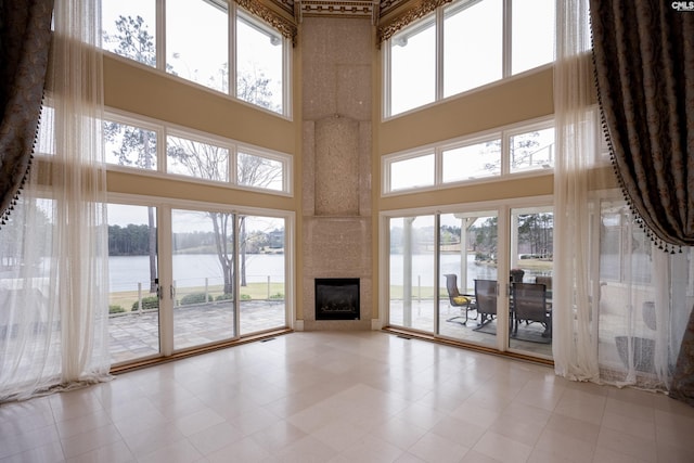 unfurnished living room with a water view and a healthy amount of sunlight
