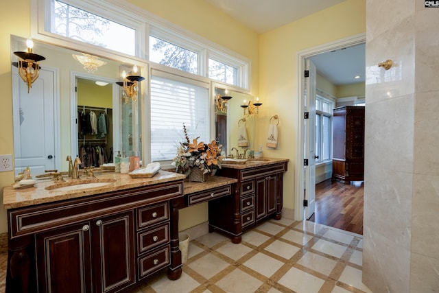 full bathroom with double vanity and a sink