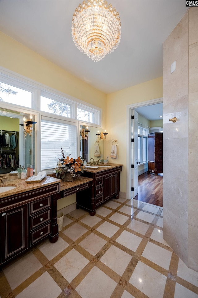 bathroom featuring vanity and a notable chandelier