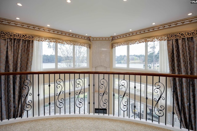 interior space with a water view, recessed lighting, and crown molding