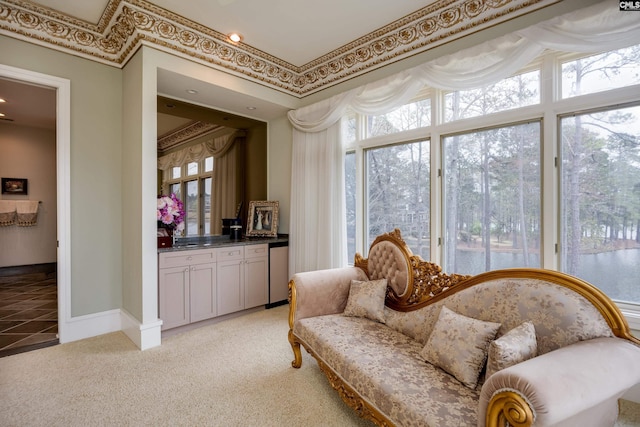 sitting room featuring light colored carpet and baseboards