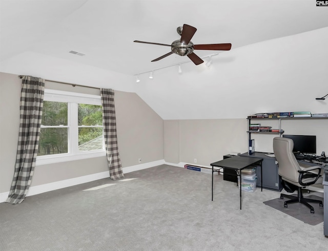 carpeted office featuring visible vents, track lighting, baseboards, ceiling fan, and lofted ceiling
