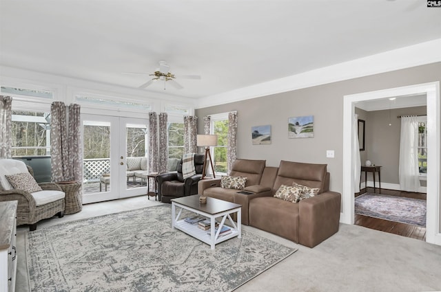 living room with french doors, wood finished floors, baseboards, and ceiling fan