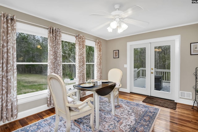 dining room featuring visible vents, baseboards, a ceiling fan, hardwood / wood-style floors, and french doors