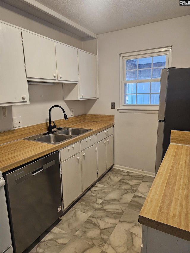 320 Cambout St, Columbia, SC 29210 - kitchen with marble finish floor, stainless steel appliances, a sink, butcher block countertops, and white cabinetry