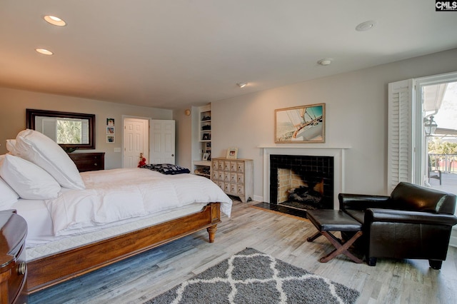 86 Rocky Cove Rd, Lexington, SC 29072 - bedroom featuring light wood-style floors, recessed lighting, and a tile fireplace