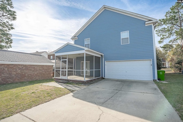 1827 Lake Carolina Dr, Columbia, SC 29229 - rear view of house with an attached garage, a sunroom, a lawn, and concrete driveway