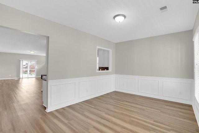 1827 Lake Carolina Dr, Columbia, SC 29229 - spare room with a wainscoted wall, light wood-style flooring, and visible vents