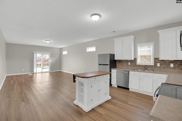 1827 Lake Carolina Dr, Columbia, SC 29229 - kitchen with a sink, open floor plan, decorative backsplash, and appliances with stainless steel finishes