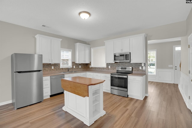 1827 Lake Carolina Dr, Columbia, SC 29229 - kitchen with white cabinetry, a sink, stainless steel appliances, and visible vents