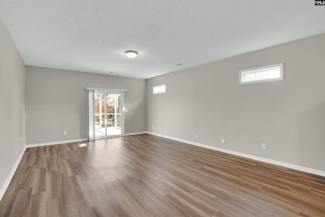 1827 Lake Carolina Dr, Columbia, SC 29229 - empty room featuring baseboards, a textured ceiling, and wood finished floors