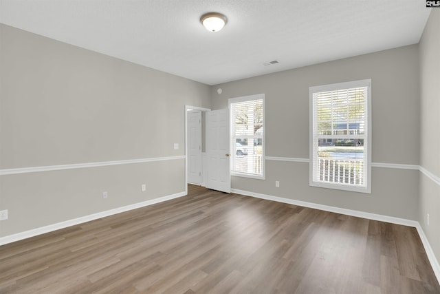 1827 Lake Carolina Dr, Columbia, SC 29229 - spare room featuring baseboards, visible vents, wood finished floors, and a textured ceiling