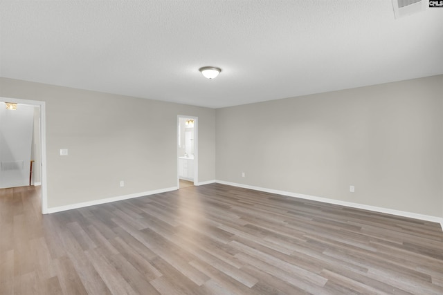 1827 Lake Carolina Dr, Columbia, SC 29229 - spare room with baseboards, visible vents, a textured ceiling, and wood finished floors
