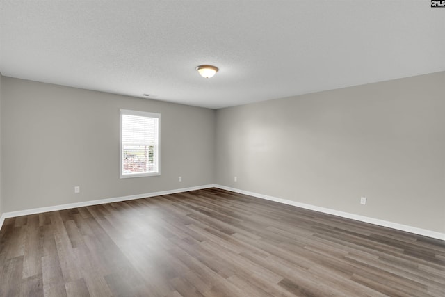 1827 Lake Carolina Dr, Columbia, SC 29229 - empty room with baseboards, visible vents, wood finished floors, and a textured ceiling