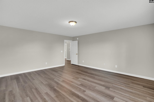 1827 Lake Carolina Dr, Columbia, SC 29229 - spare room with baseboards, wood finished floors, and a textured ceiling