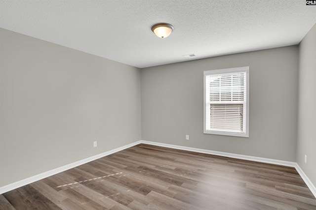 1827 Lake Carolina Dr, Columbia, SC 29229 - spare room with baseboards, a textured ceiling, and wood finished floors