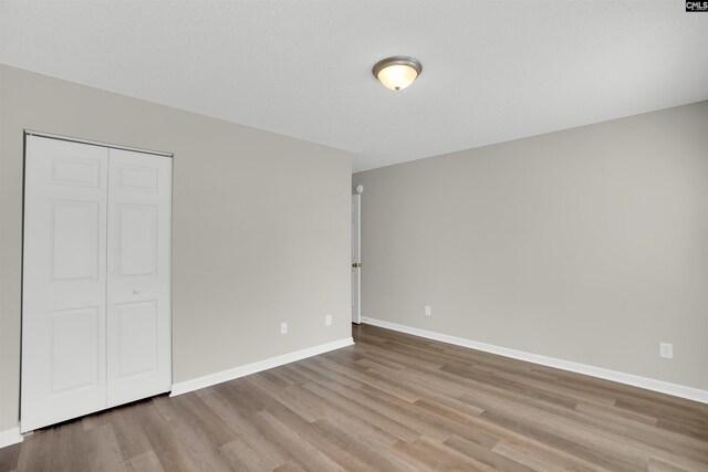 1827 Lake Carolina Dr, Columbia, SC 29229 - unfurnished bedroom with baseboards, wood finished floors, and a closet