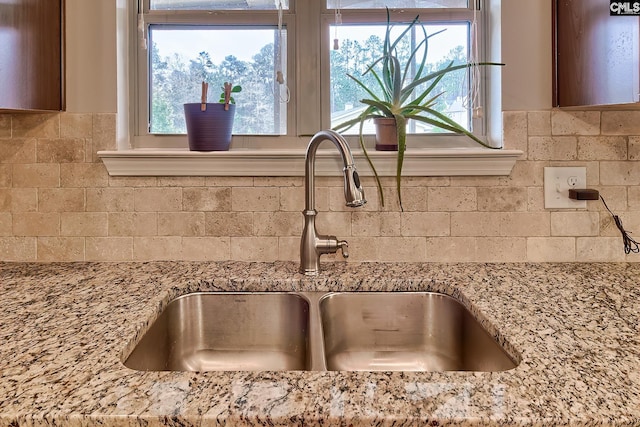 room details with light stone counters and a sink