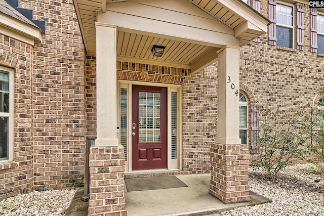 property entrance featuring brick siding