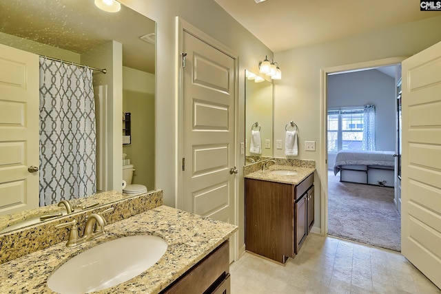 full bath featuring a sink, two vanities, and a shower with shower curtain