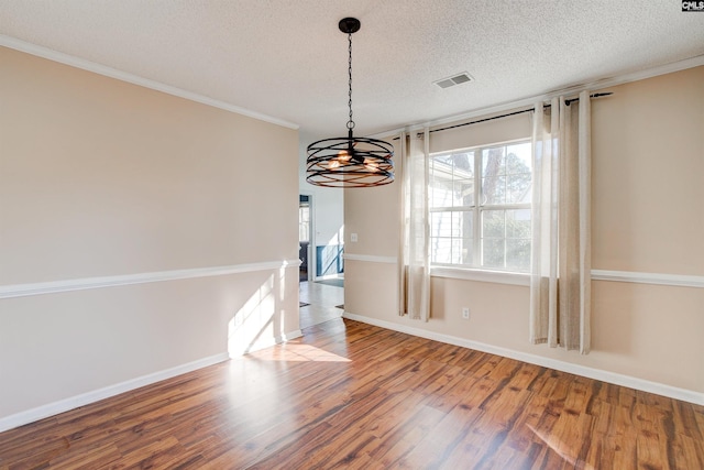 113 Silverstone Rd, Lexington, SC 29072 - unfurnished dining area with crown molding, a chandelier, a textured ceiling, visible vents, and wood finished floors