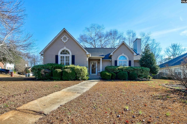 113 Silverstone Rd, Lexington, SC 29072 - view of front facade with stucco siding, roof with shingles, and a chimney