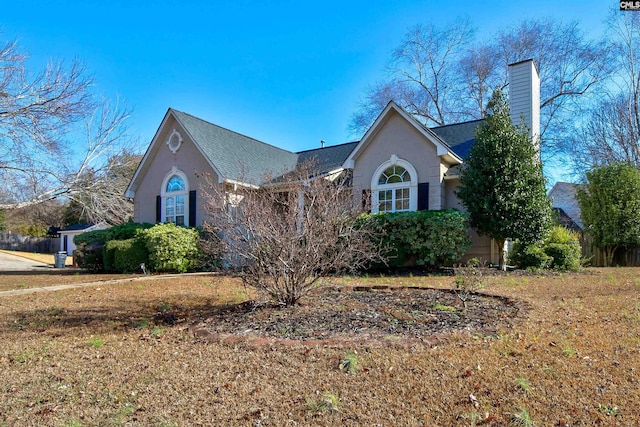 113 Silverstone Rd, Lexington, SC 29072 - view of front of home featuring stucco siding, a chimney, and a shingled roof