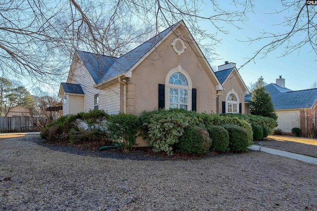 113 Silverstone Rd, Lexington, SC 29072 - view of property exterior featuring stucco siding, fence, and a chimney