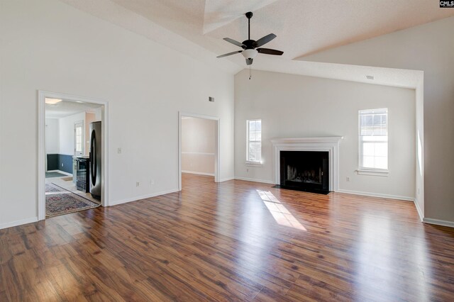 113 Silverstone Rd, Lexington, SC 29072 - unfurnished living room featuring a fireplace with flush hearth, high vaulted ceiling, baseboards, ceiling fan, and wood finished floors