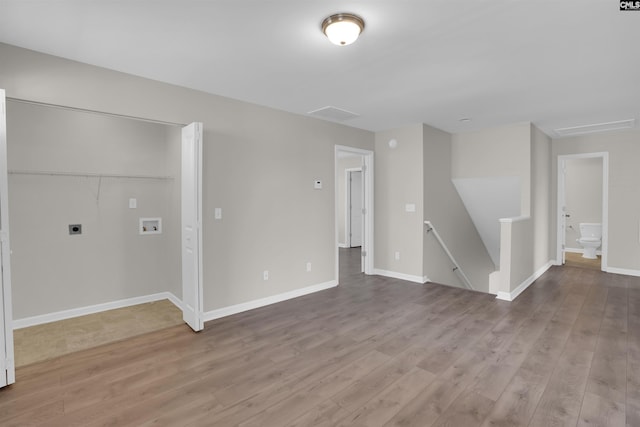 interior space featuring baseboards and wood finished floors