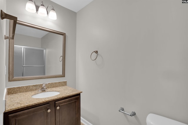 full bathroom with an enclosed shower, toilet, and vanity