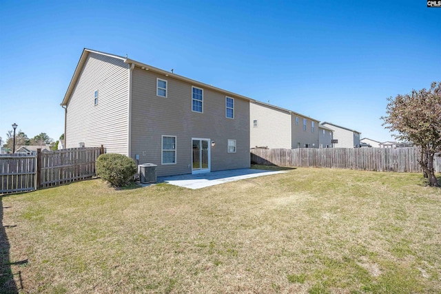 rear view of house with a lawn, a fenced backyard, a patio, and central AC