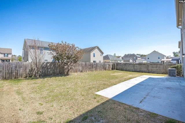 view of yard with central AC unit, a residential view, a fenced backyard, and a patio