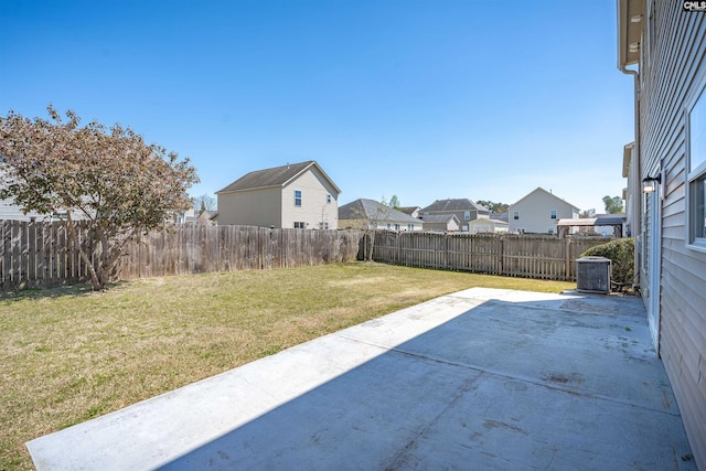 view of yard with a fenced backyard, a residential view, and a patio