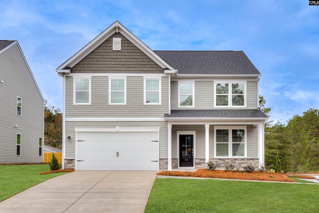 craftsman inspired home featuring stone siding, driveway, and a front lawn