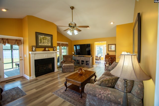 living area with wood finished floors, a healthy amount of sunlight, and a ceiling fan