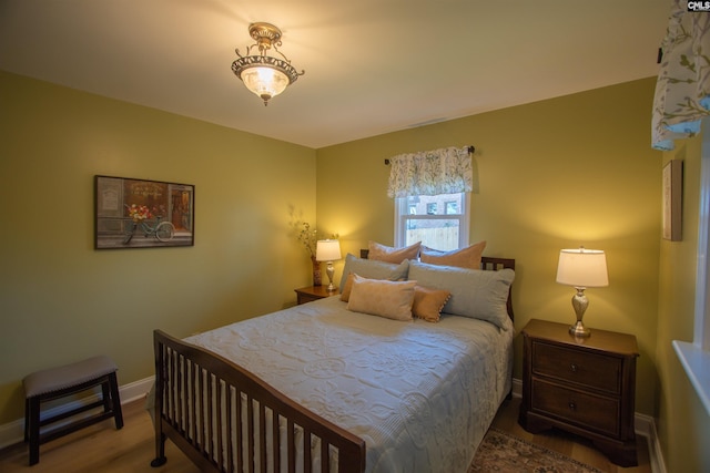 bedroom featuring baseboards and wood finished floors
