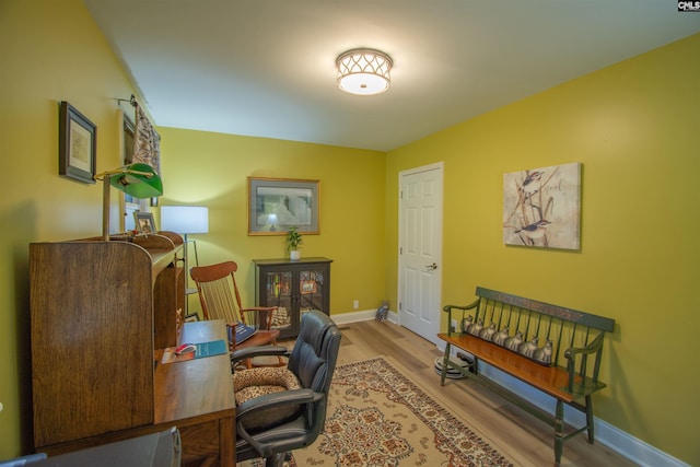 office space featuring baseboards and wood finished floors