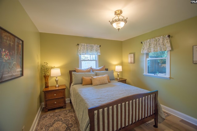 bedroom featuring baseboards and wood finished floors