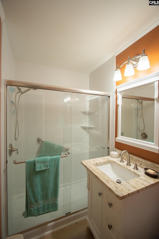 full bath with vanity and a shower stall