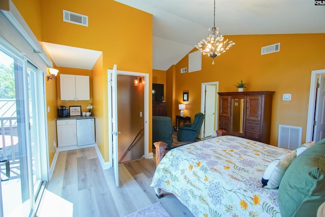 bedroom featuring an inviting chandelier, light wood-style flooring, and visible vents