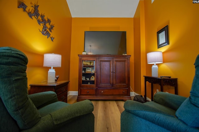 living room with baseboards and light wood-style floors