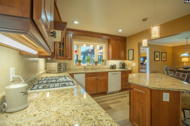 kitchen featuring white appliances, light wood finished floors, light stone countertops, brown cabinetry, and glass insert cabinets