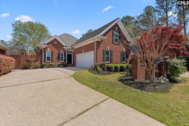traditional home with brick siding, concrete driveway, a garage, and a front lawn
