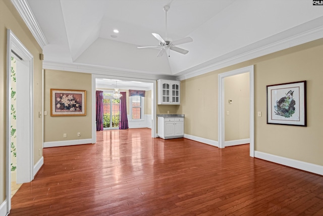 unfurnished living room featuring baseboards, wood-type flooring, ornamental molding, and a ceiling fan