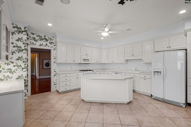 kitchen with light countertops, white appliances, light tile patterned floors, a sink, and ceiling fan