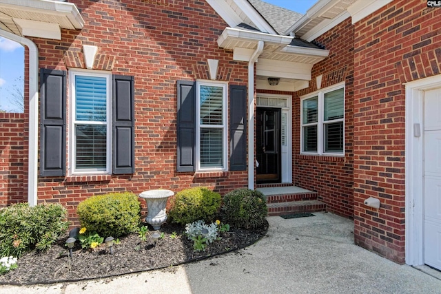property entrance featuring brick siding