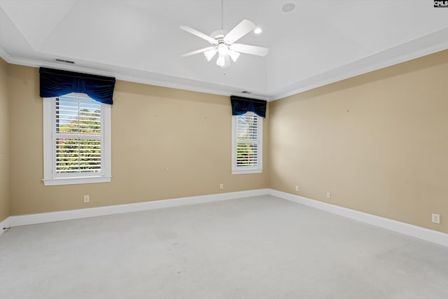 unfurnished room featuring plenty of natural light, vaulted ceiling, carpet, and a ceiling fan