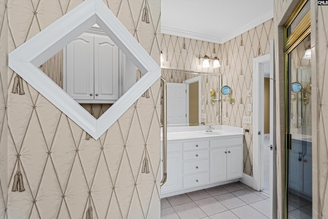 bathroom with wallpapered walls, vanity, ornamental molding, and tile patterned flooring