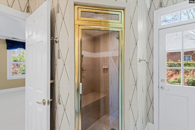 bathroom with baseboards and a shower stall
